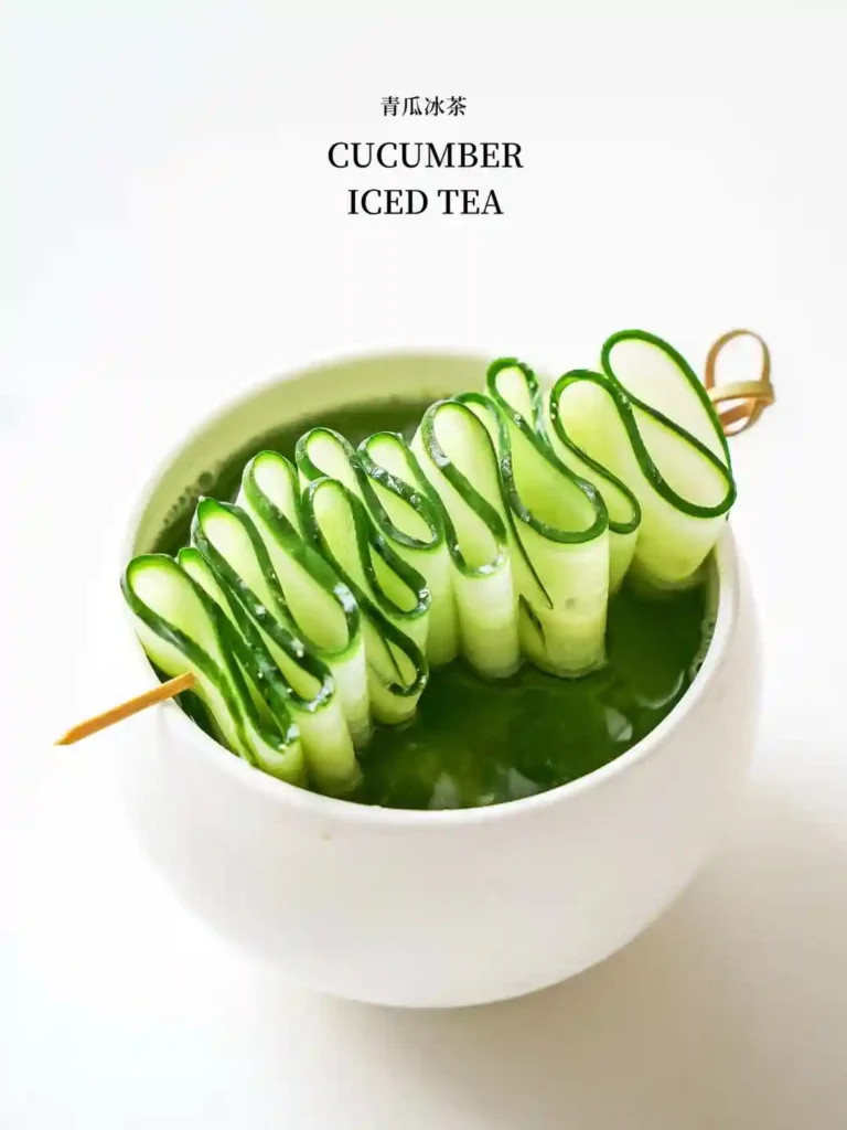 Cucumber iced tea with spiral - cut cucumber slices, served in a white cup.