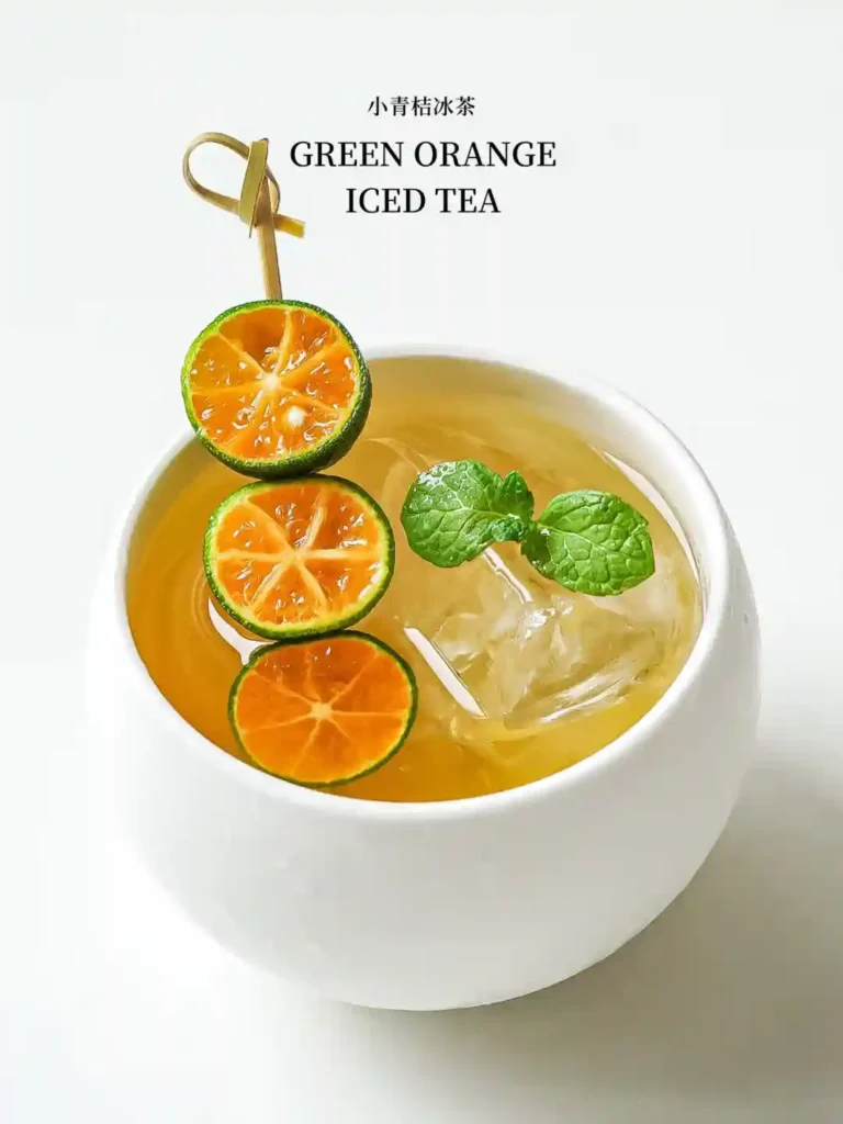 Lime wheel iced tea with green orange slices and mint, served in a white cup.